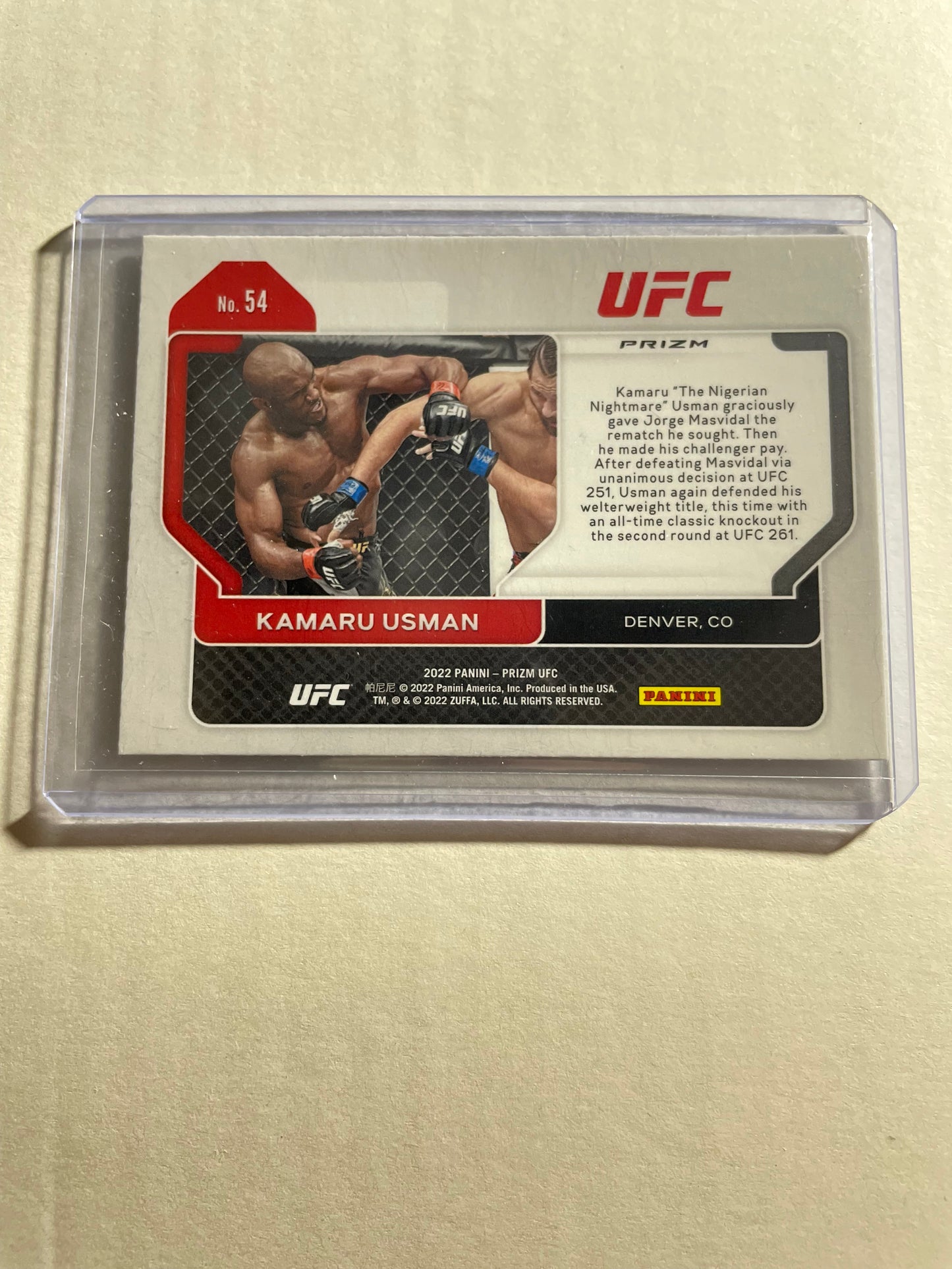 2022 Panini Prizm UFC Kamaru Usman Red Prizm trading card, featuring a shiny red holographic background and serial-numbered parallel