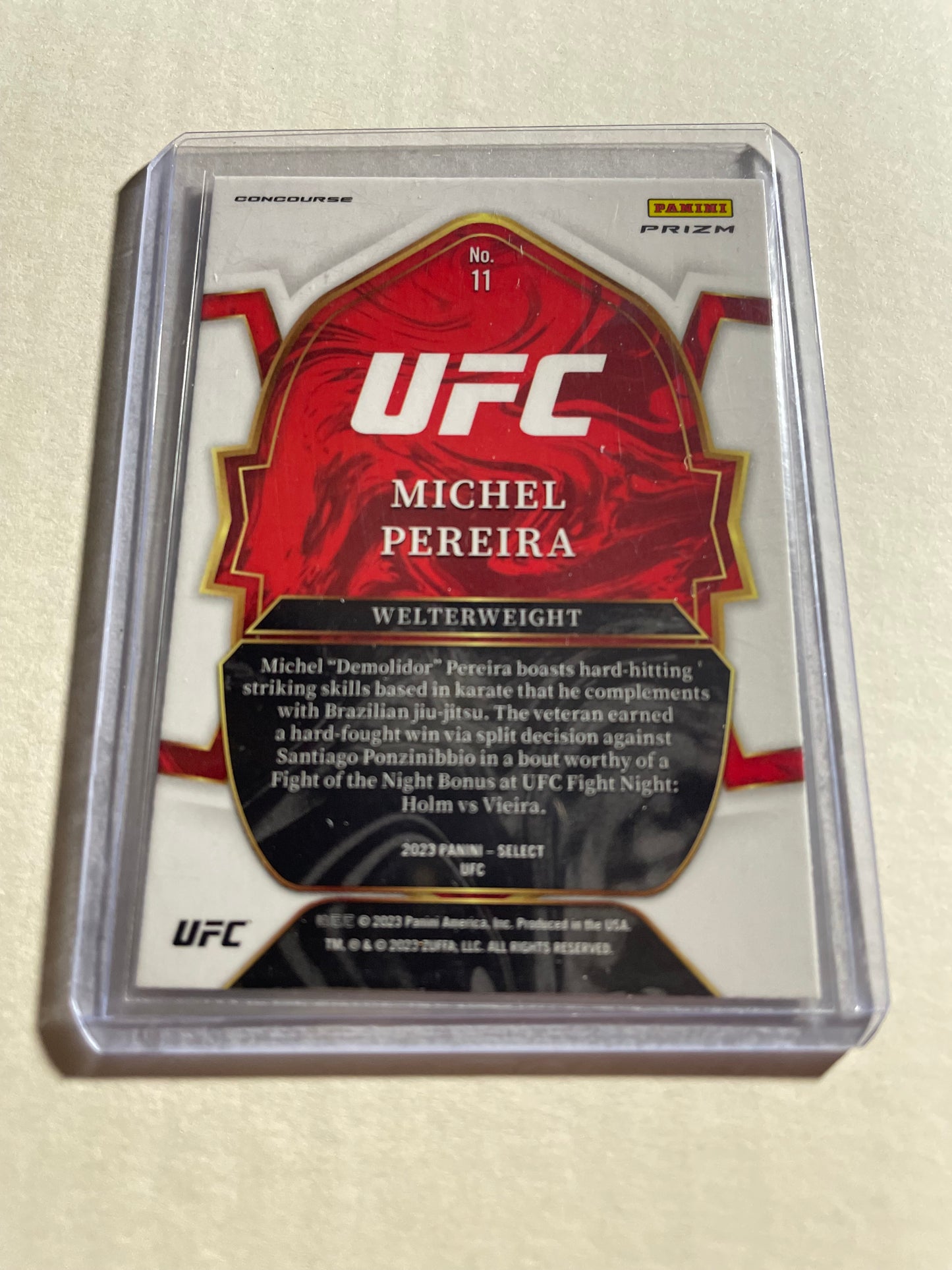 2023 Panini Select UFC Michel Pereira #11 Concourse card, which features a vibrant red and blue Prizm design.