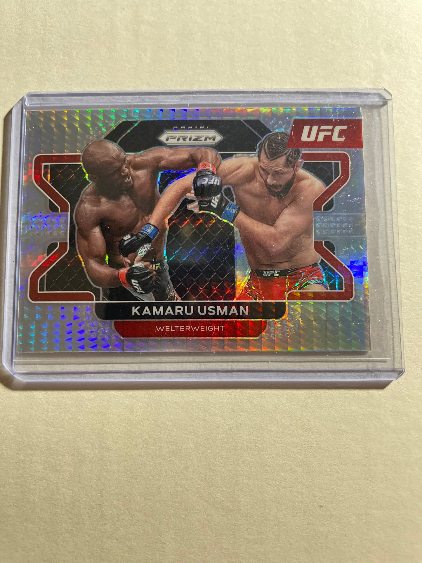 2022 Panini Prizm UFC Kamaru Usman Red Prizm trading card, featuring a shiny red holographic background and serial-numbered parallel
