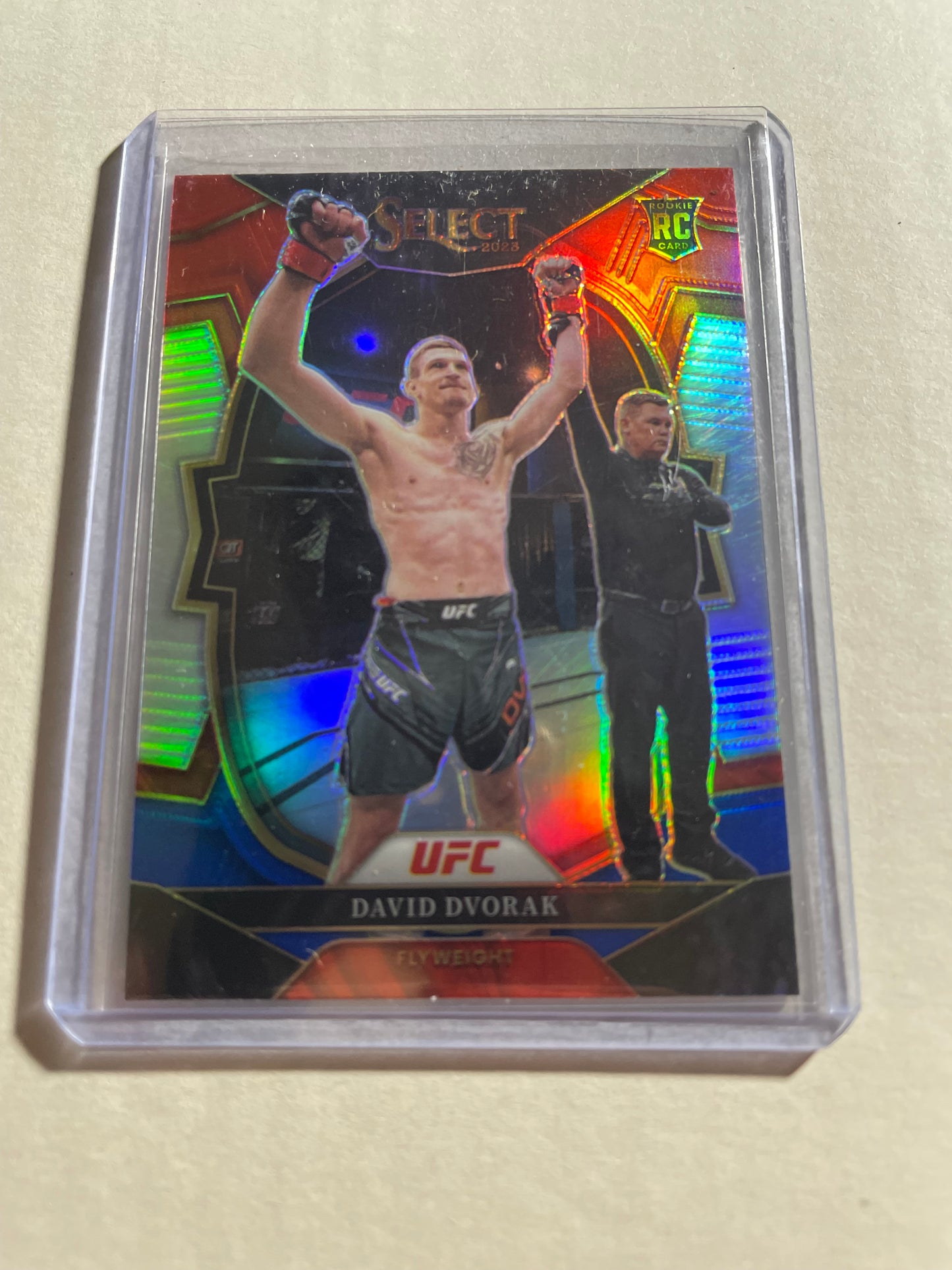 2023 Panini Select UFC David Dvorak Rookie Card from the Concourse set.The card features a vibrant tri-color prizm design with red and blue parallels.It is identified as card #42 in the set and features the official "RC" rookie logo.