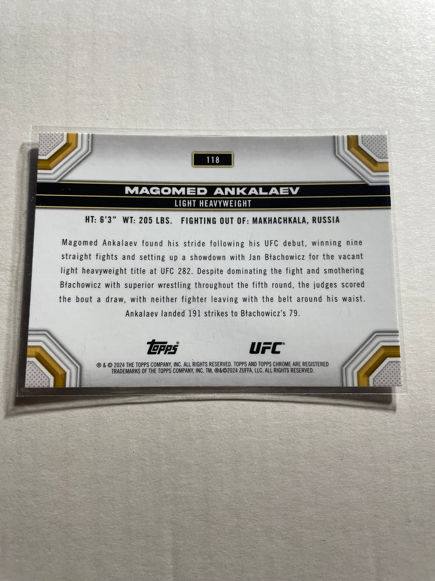 2024 Topps Chrome UFC #118 Magomed Ankalaev base card.It features a chrome finish with a distinct black, silver, and gold border design.