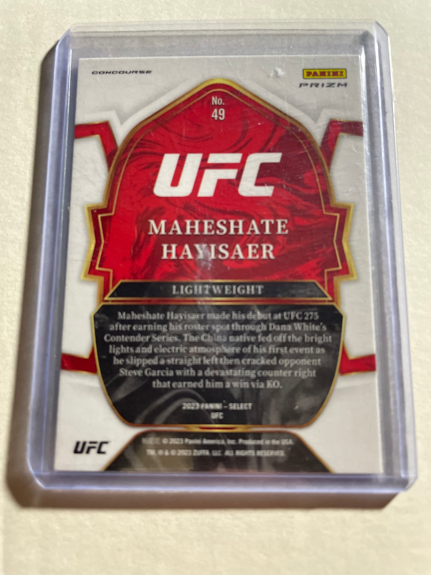 2023 Panini Select UFC Concourse Red & Blue Prizm rookie card (#49) features fighter Maheshate Hayisaer.